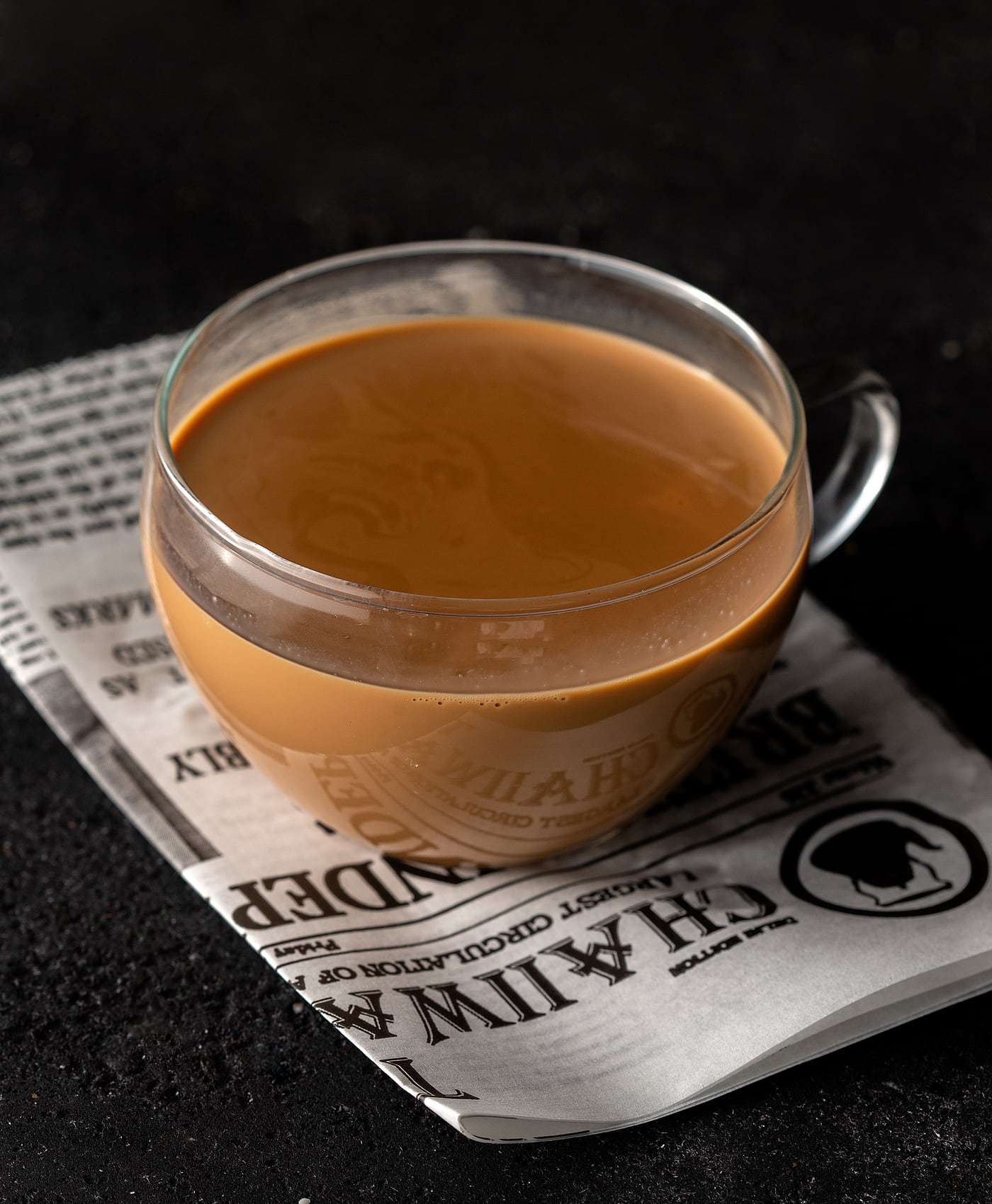A glass cup of strong, milky chai
